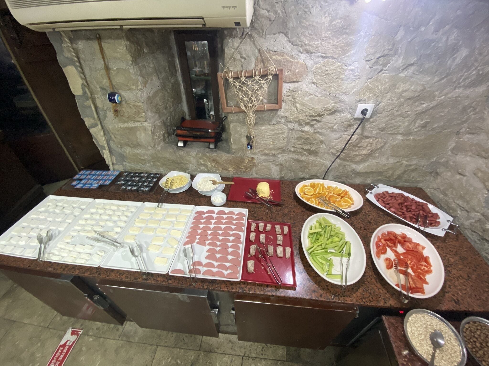 A buffet spread with various food items and utensils.