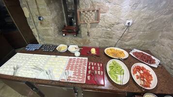A buffet spread with various food items and utensils.