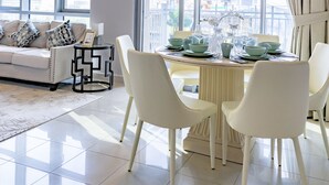 Un soggiorno moderno con zona pranzo, ampie finestre e vista su un cantiere edile.