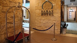 A hotel entrance with a metal barrier and a sign that reads "SARAY HOTEL". - Saray Hotel (Amman)