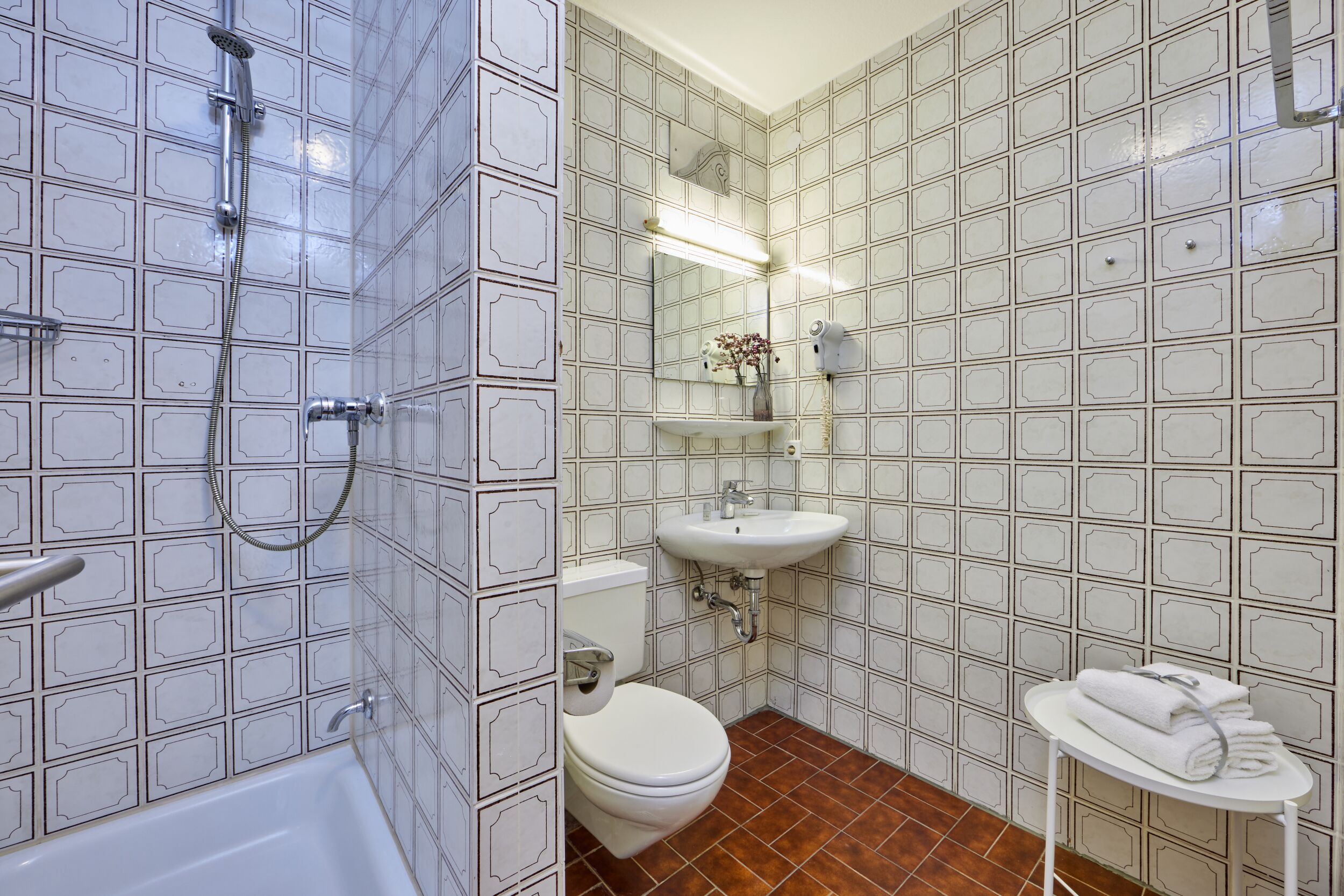 standard single room | bathroom | shower, hair dryer, towels, toilet paper