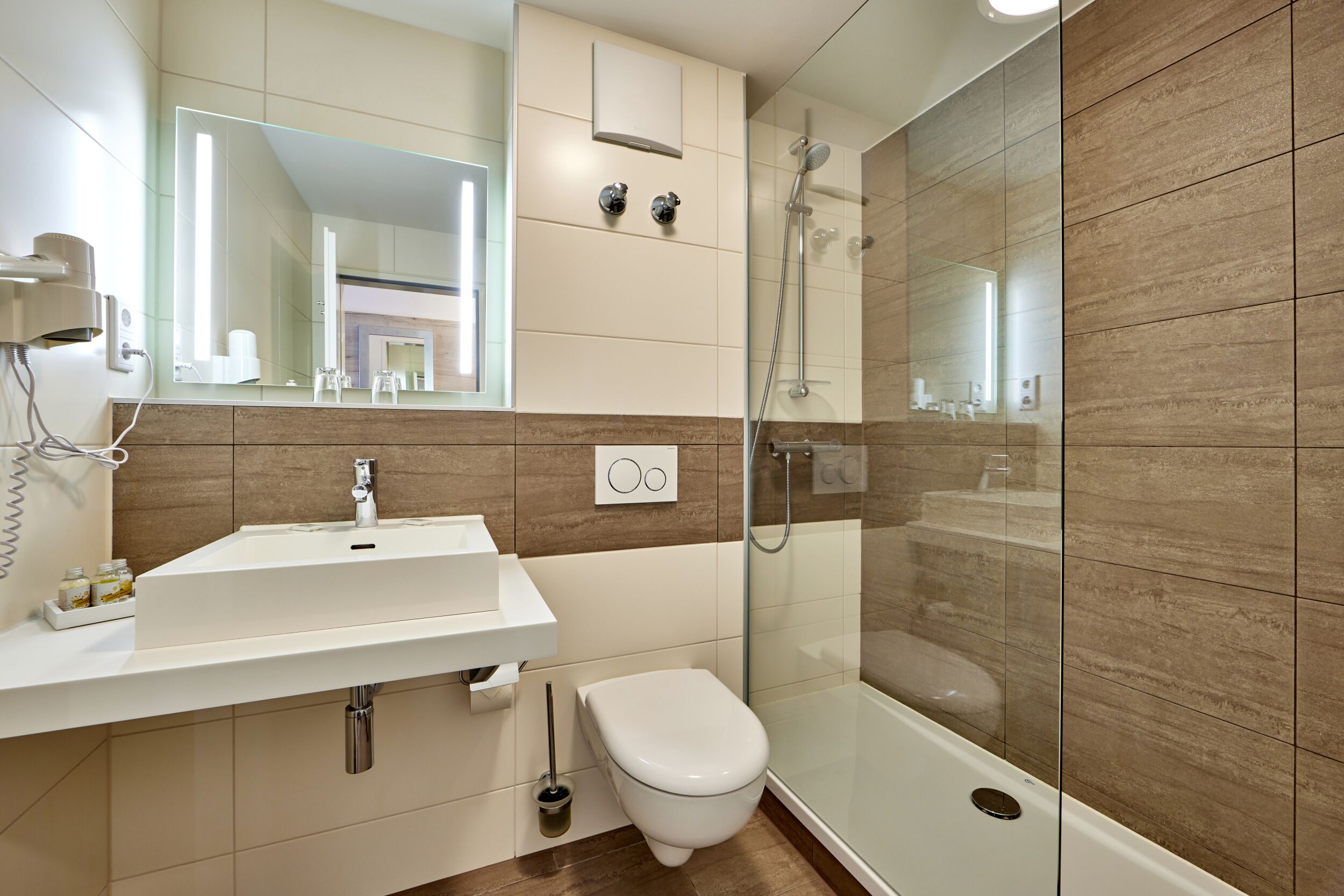 premium single room | bathroom | shower, hair dryer, towels, toilet paper