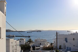 A coastal town with white buildings, a clear sky, and boats on the water. - Stelios View Mykonos Town (Mykonos)