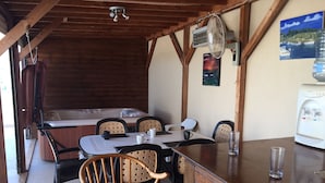 A rustic dining area with wooden furniture, a table with chairs, a water dispenser, and a painting on the wall. - Penthouse Spacious  2 Bedroom Apartment with massive balcony in lovely Town (Xylofagou)