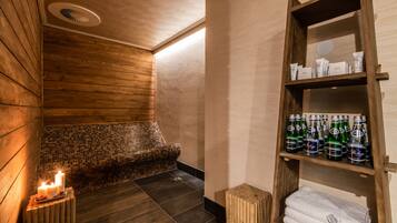 Relax in a serene spa room with a bathtub, toiletries, and a comfortable bench.