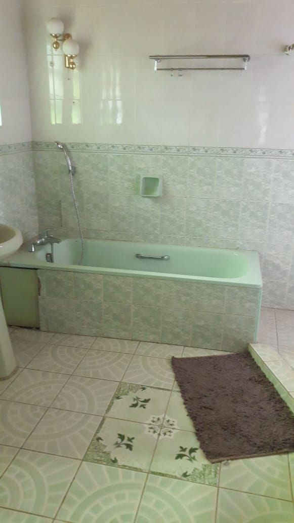 A bathroom with a bathtub, a sink, and a shower.