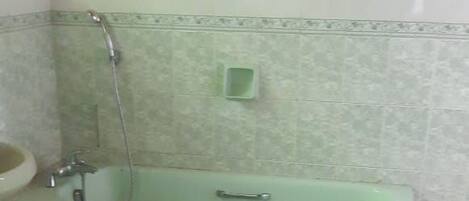 A bathroom with a bathtub, a sink, and a shower.