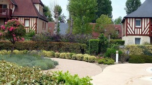 A traditional half-timbered house with a garden in front.
