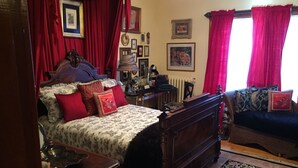 A traditional bedroom with a four-poster bed, a wooden dresser, and a sofa. - The Coach House (St. Stephen)