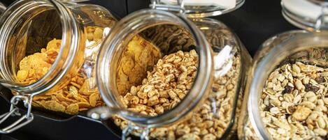 Glass jars with metal lids containing various food items.