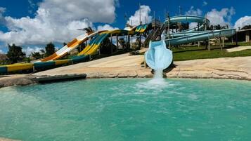 A water park with multiple water slides and a pool.