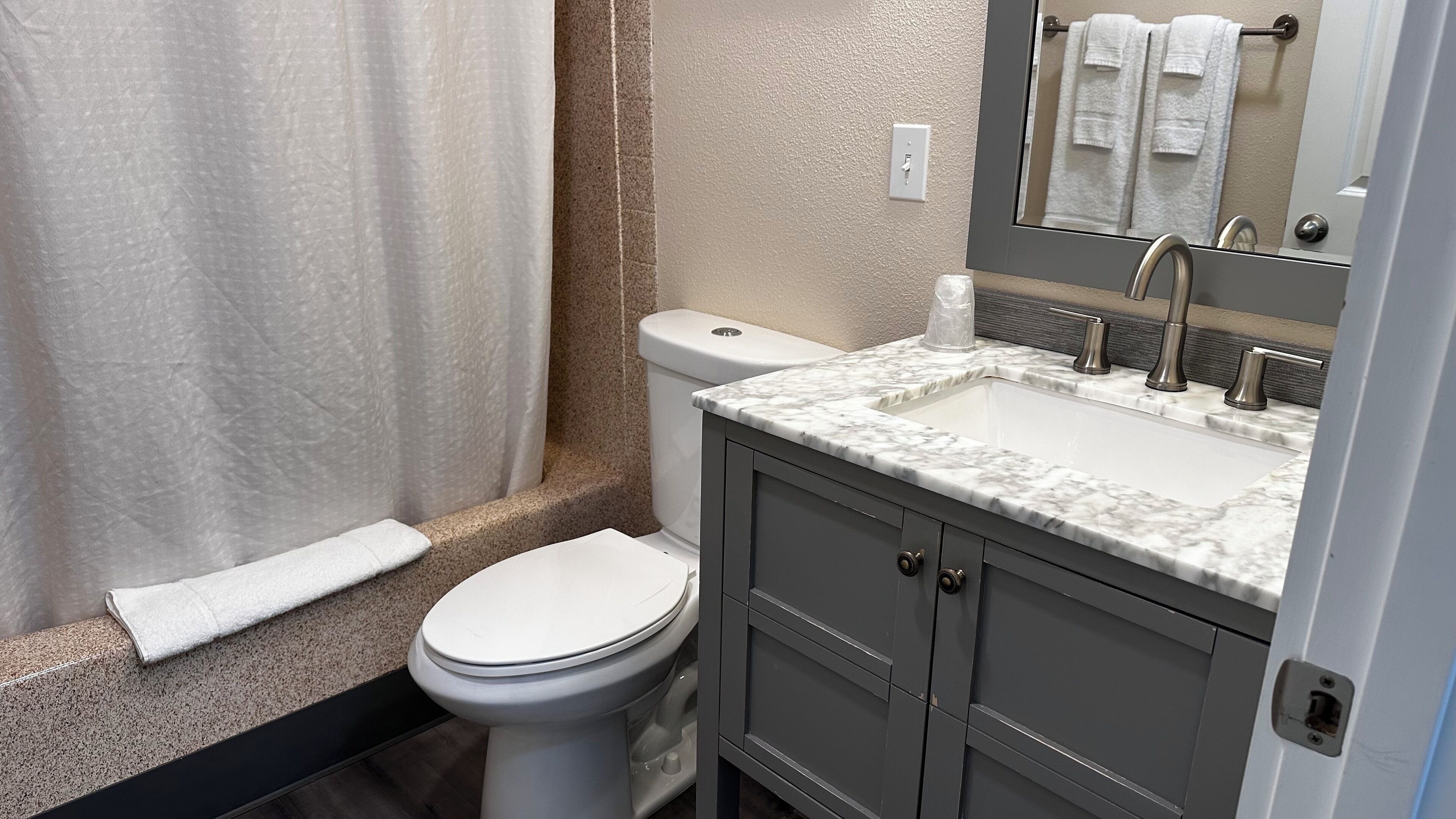 king studio | bathroom | combined shower/bathtub, hair dryer, towels