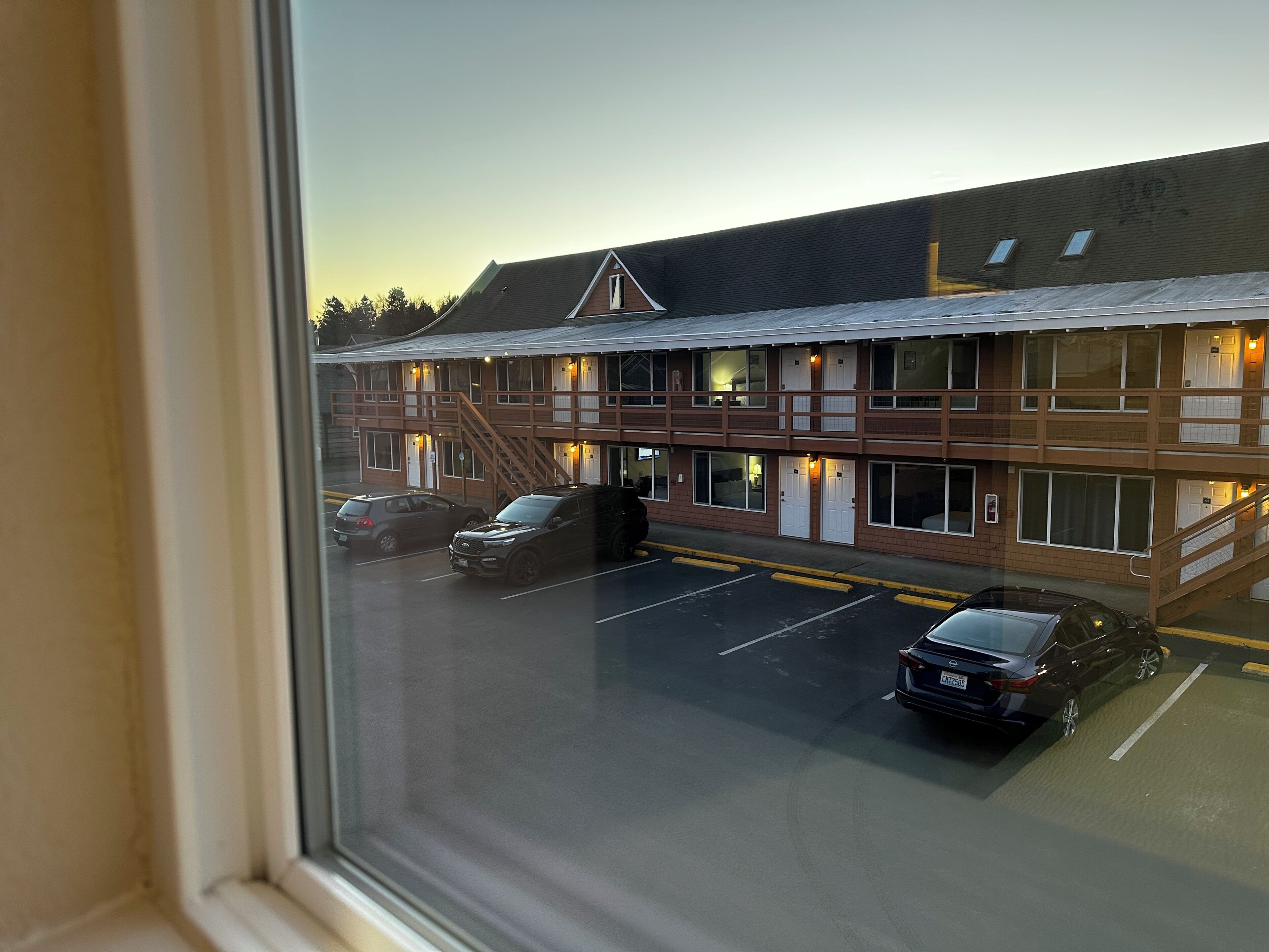 A two-story motel with a parking lot.