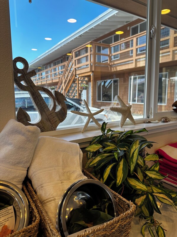A view through a window with wooden decor, a plant, and a basket with items.