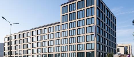 A modern multi-story hotel with a grid of windows, a prominent entrance, and a visible sign for the Premier Inn.