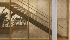 A modern interior with a geometric patterned floor, a staircase, and a mesh partition. - Mövenpick Hotel Stuttgart Messe & Congress (Leinfelden-Echterdingen)