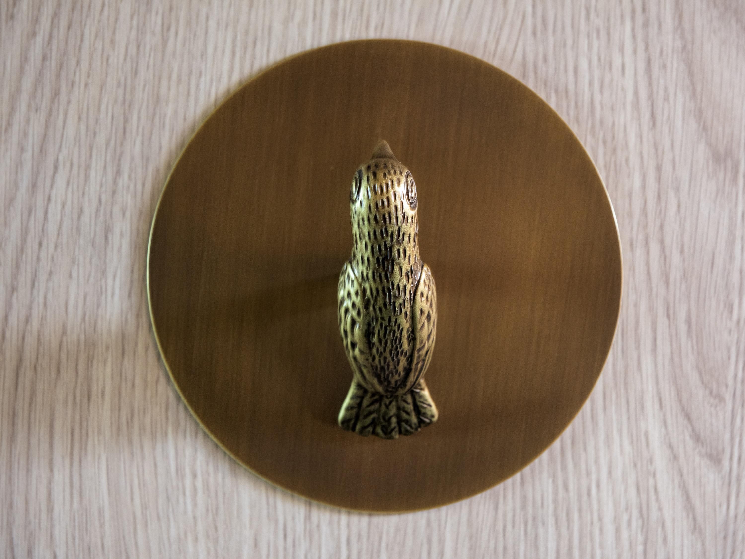 A bird-shaped object on a wooden surface.