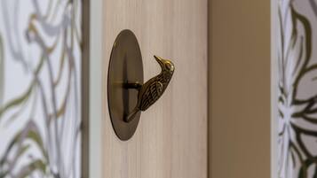 A wall-mounted door handle with a bird-shaped design.