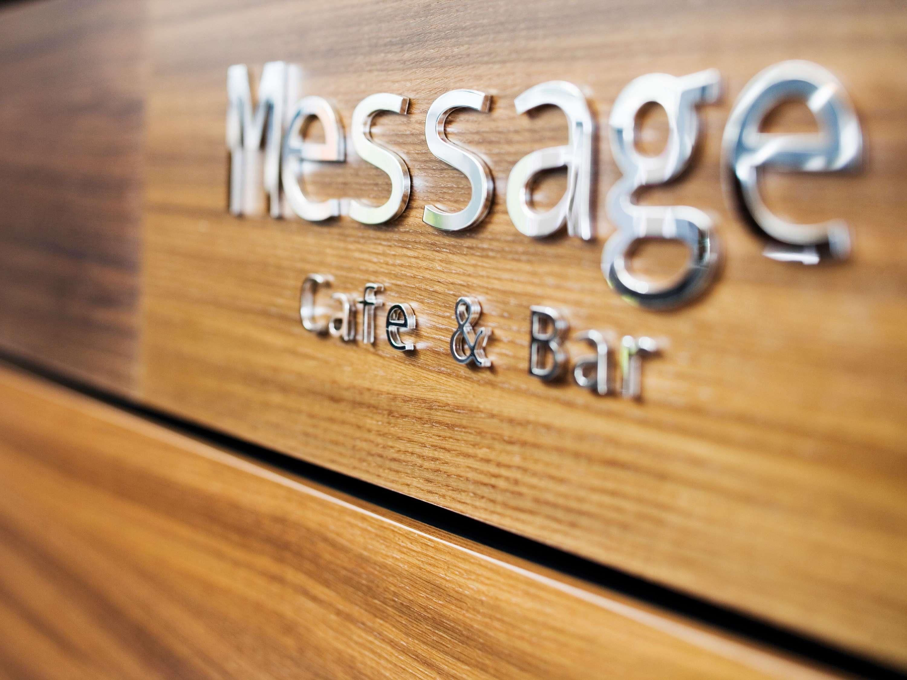 A wooden surface with the words 'Message Cafe & Bar' engraved on it.
