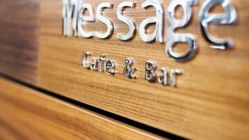 A wooden surface with the words 'Message Cafe & Bar' engraved on it.