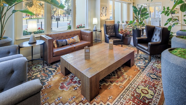 A spacious lobby with high ceilings, large windows, and a variety of seating options including sofas and chairs. - Hotel E (Santa Rosa)