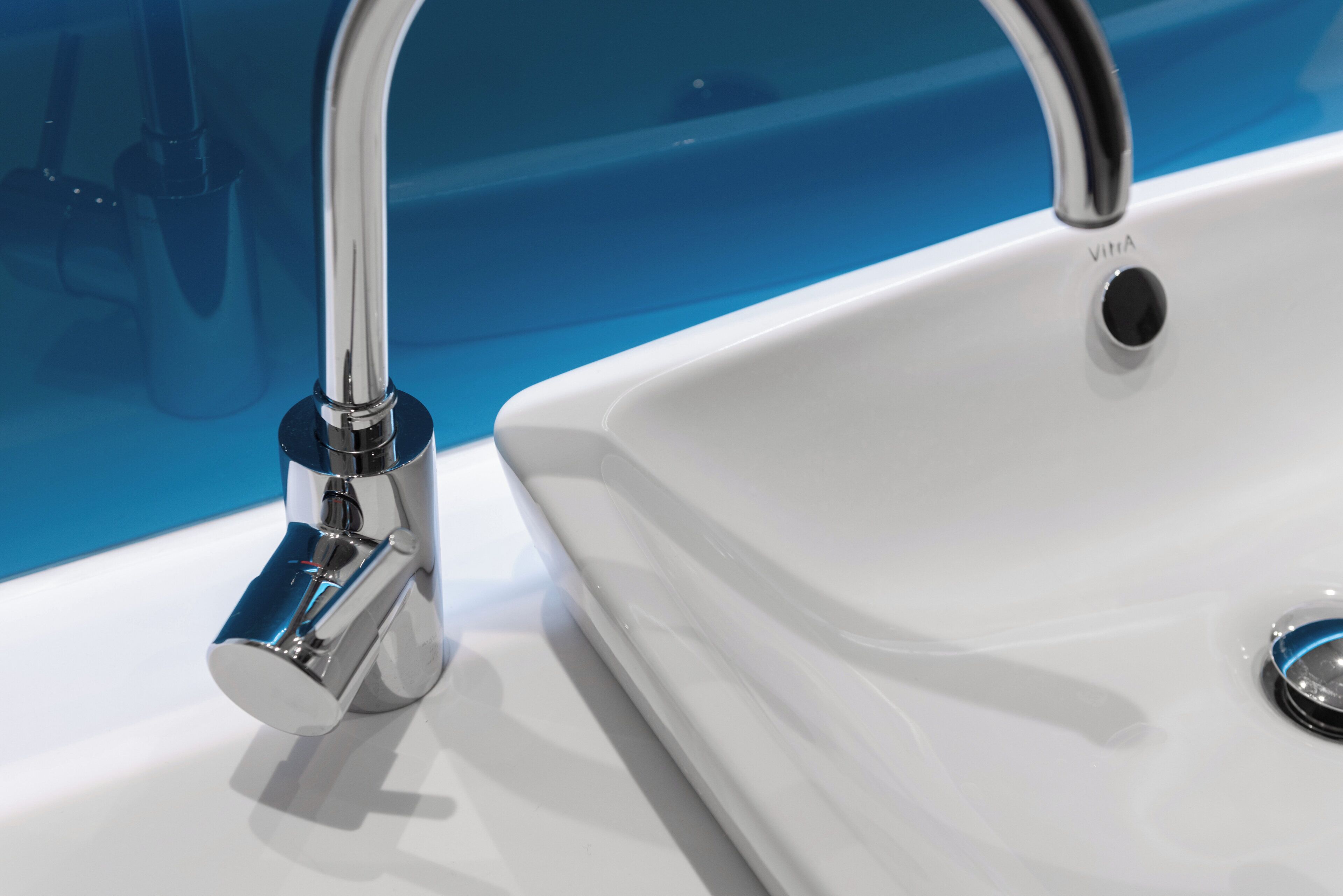 A modern bathroom sink with a chrome faucet and a white basin.