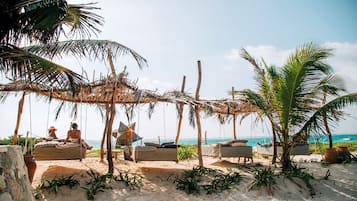 On the beach, white sand, sun-loungers, beach umbrellas