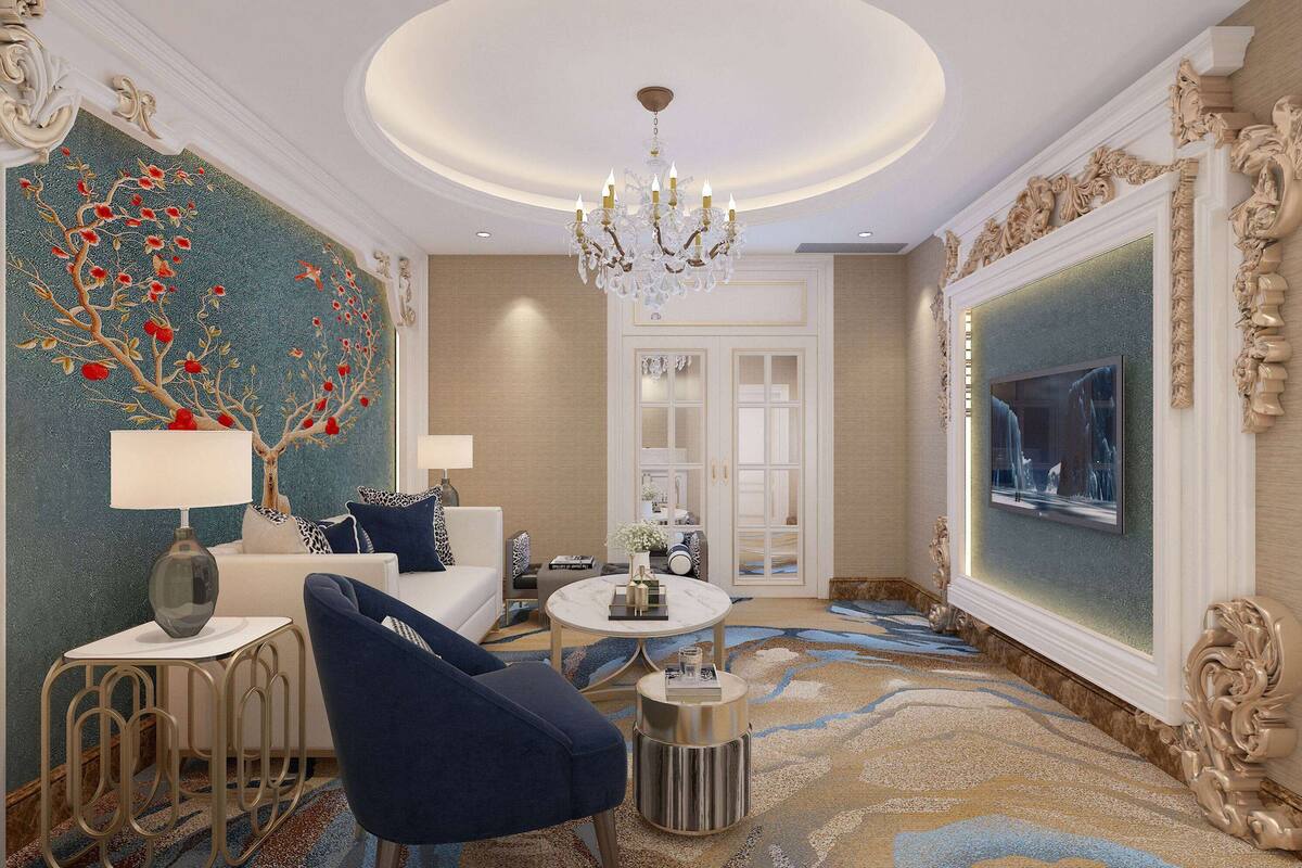 A luxurious room with a chandelier, a white sofa, a round coffee table, and a decorative tree mural on the wall.
