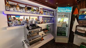 Enjoy a drink at the bar, where a well-stocked counter and coffee machine await.