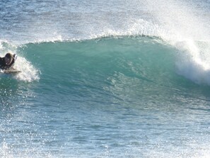 A surfer riding a large wave in the ocean.