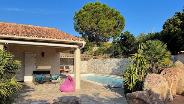 A pool area with a stone patio, lounge chairs, and a covered seating area. - The ideal place to relax, Beautiful villa with all the comforts (Sainte-Lucie de Porto-Vecchio)