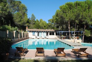 An infinity pool, pool loungers