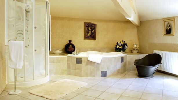 A bathroom with a glass shower enclosure, a bathtub, and a large black bathtub. -  A privileged vacation out of time, Be the Châtelains of the Manor.     (Birac-sur-Trec)