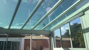A modern building with a glass ceiling and large windows.