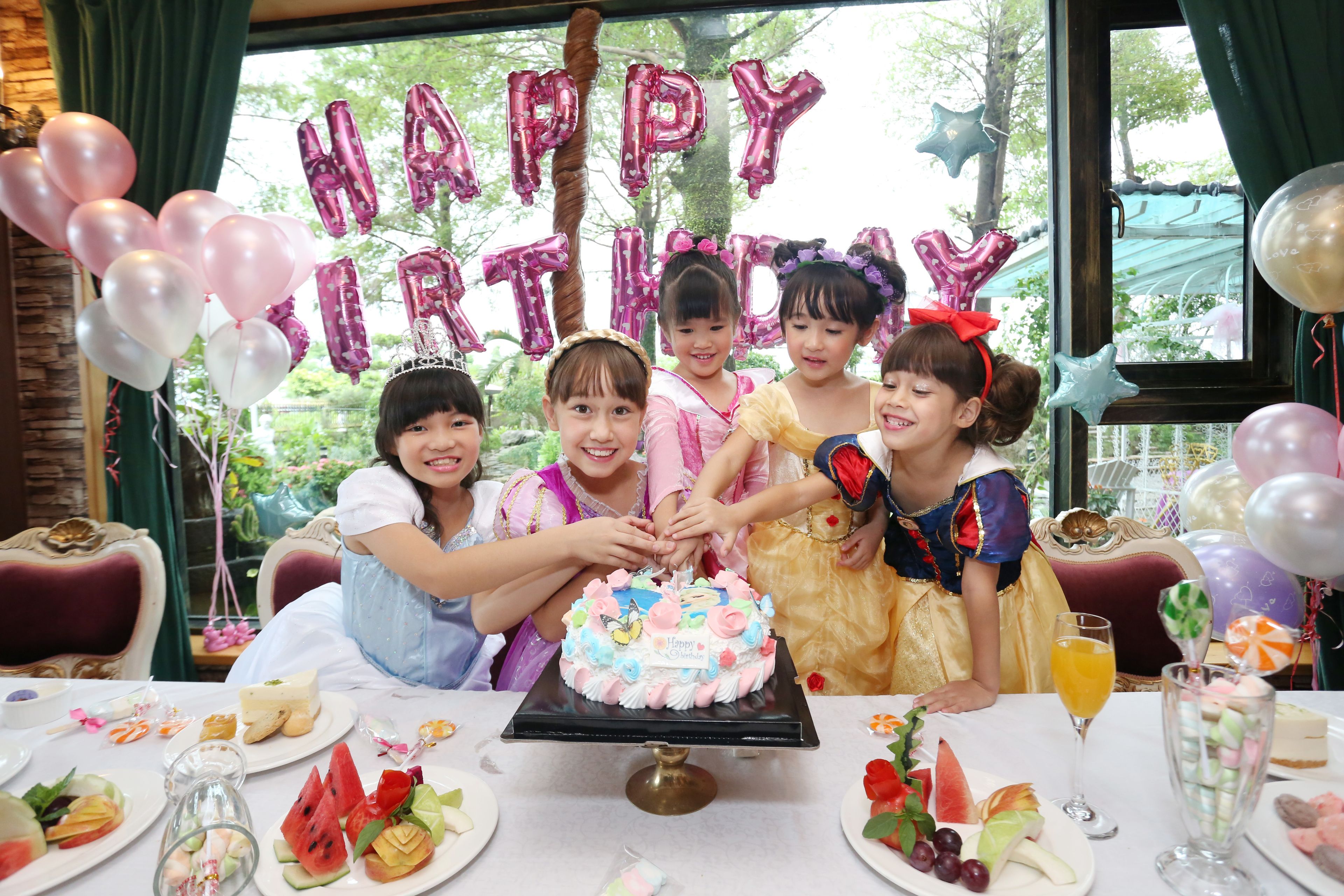A birthday party with a cake and balloons.