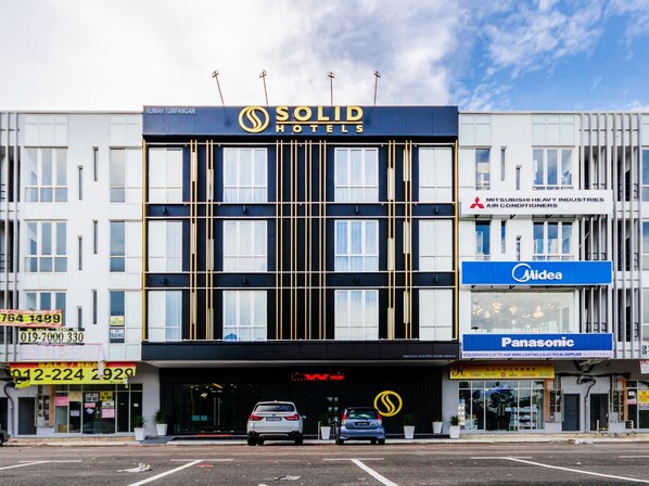 A hotel with a modern facade, featuring a prominent 'Solid Hotels' sign. - Solid Hotels (Masai)