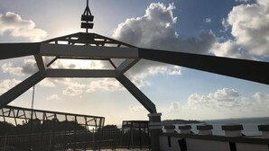 A view of a bridge with a tall tower structure in the background. - Nite & Day Laguna Bintan - Tanjungpinang (Tanjung Pinang)