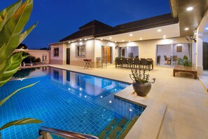 A modern hotel with a swimming pool, outdoor seating area, and a covered patio. - Villa Bos Near the Beach of Jomtien (Pattaya)