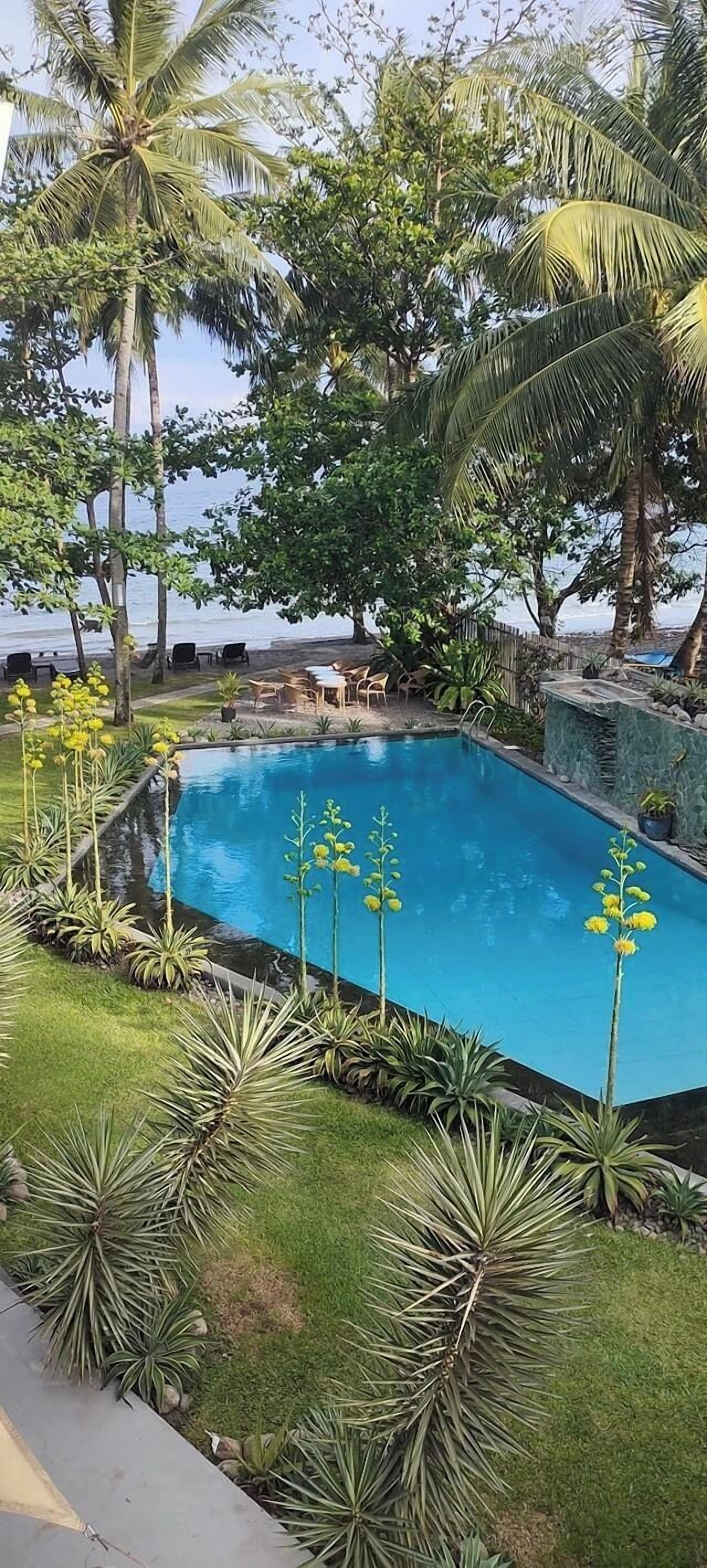 Habitación Deluxe, 1 cama Queen size, vista parcial al océano | Vista a la playa o el mar