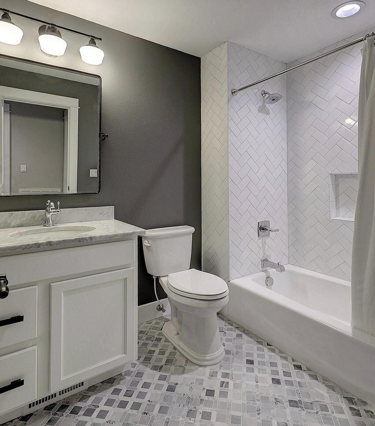 A bathroom with a toilet, sink, and bathtub.