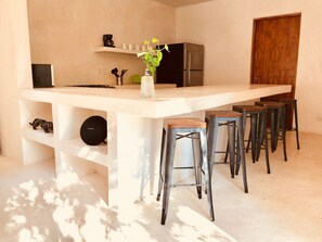 Enjoy cooking in this well-equipped kitchen with a central island, stove, and refrigerator.