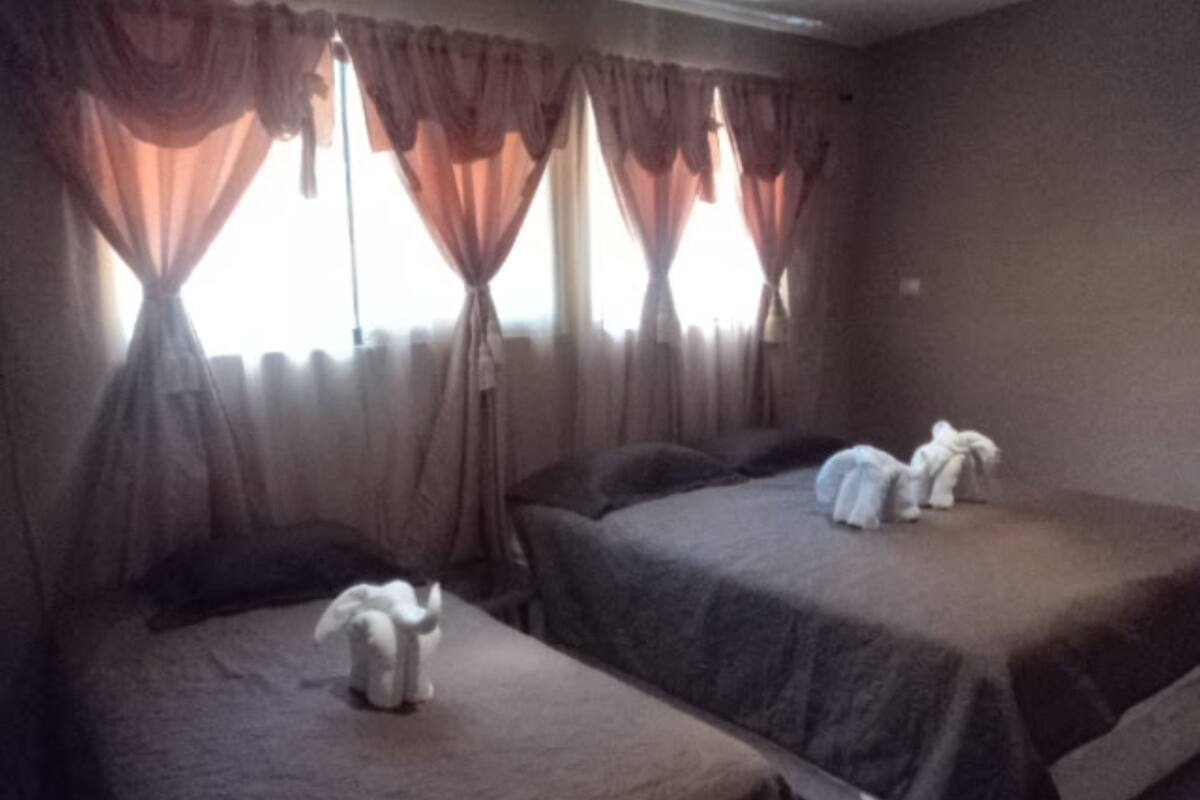 Une chambre d’hôtel avec deux lits, chacun étant équipé d’un oreiller et d’une serviette blanche.