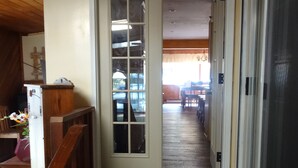 A wooden staircase leading to a room with a sliding glass door. - September Dates Open! Year Round Fun For The Whole Family! Municipal Utilities (Honeoye)
