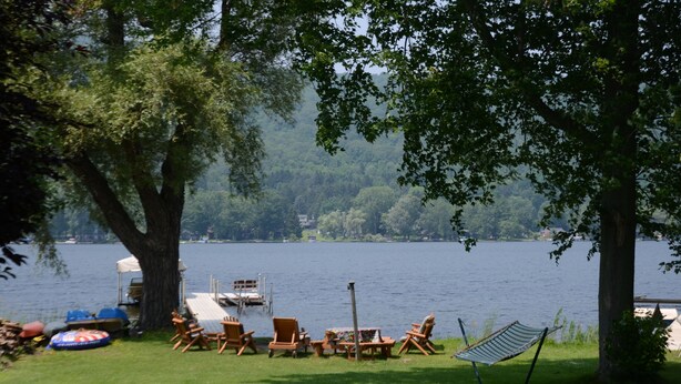 A lakeside setting with a dock, lounge chairs, and a hammock. - September Dates Open! Year Round Fun For The Whole Family! Municipal Utilities (Honeoye)