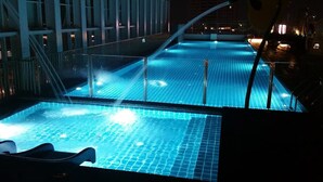 An indoor swimming pool with clear blue water, a glass barrier, and a modern architectural background. - JB Town Executive Suite (Johor Bahru)