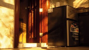 A kitchen with a refrigerator, a wooden cabinet, and a marble countertop. - Don Remegio Villas (General Luna)
