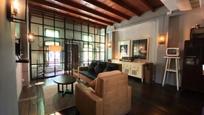 Una sala moderna con sofá, mesa de centro y mueble para televisión.