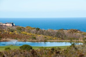A coastal landscape with a lake, trees, and a building with a view of the sea. - 9 Sheerline (Knysna)