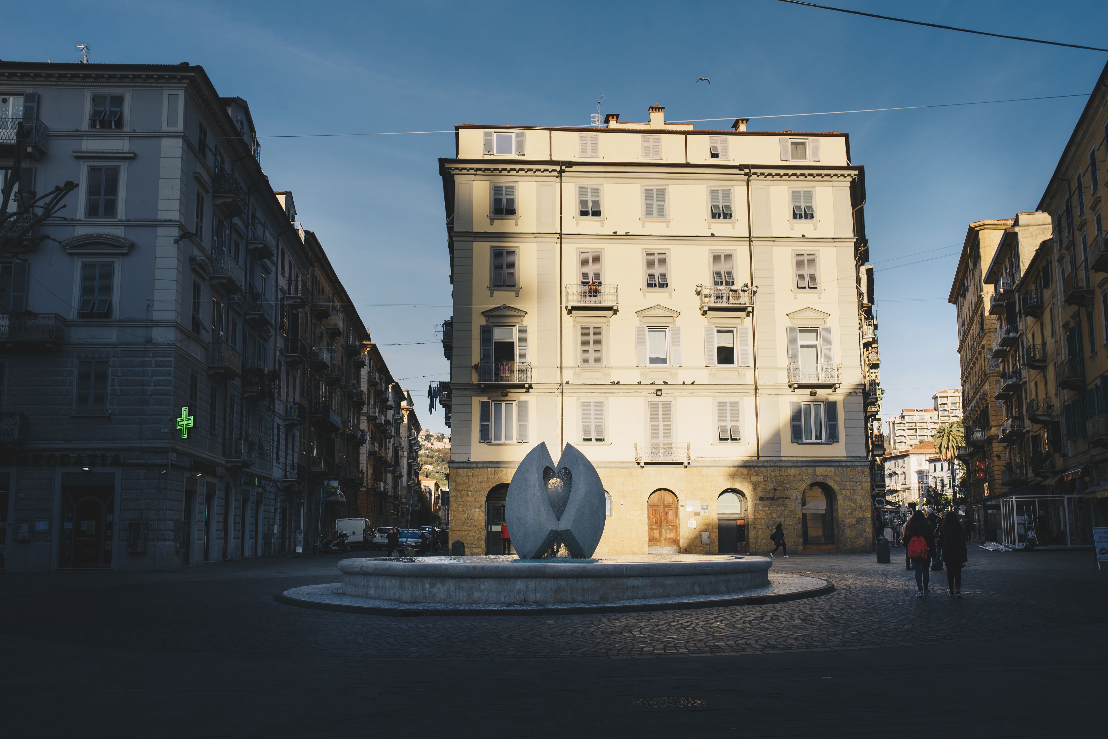 A building with a central courtyard, a fountain, and a large sculpture.