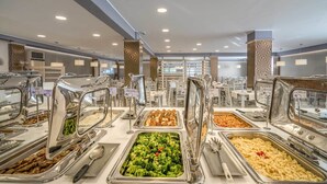 A buffet with various food options including pasta, vegetables, and meats. - Golden Sun Hotel (Zakynthos)